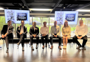 The panelists, moderator, and emcee for ULI Ottawa's event sit on stage for a team photo. From Left to Right: Greg Winters, Daniel Byrne, Guy Levesque, Andy Thompson, Terry Young, Veronica Farmer, and Stephen Willis.