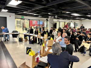 Judges and hackers network on the final night of the DT Hacks 2024 hackathon.