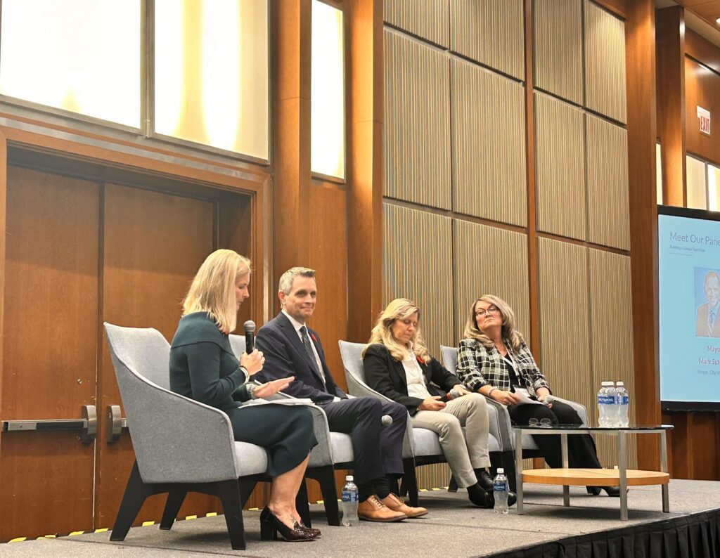 TechTuesday's speakers, Mayor Mark Sutcliffe, Councilor Curry, and KNBA Executive Director Kelly Daize sit on the stage at the Brookstreet Hotel next to the moderator, Veronica Farmer of Wesley Clover.