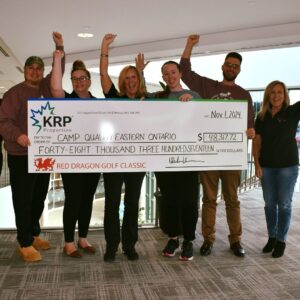 KRP and Camp Quality representatives stand with their charity cheque.