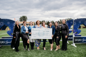 Representatives from Wesley Clover, RBC, and the Queensway Carleton Hospital hold the check for over $100K, representing the amount raised at Spurs and Sparkles 2024.